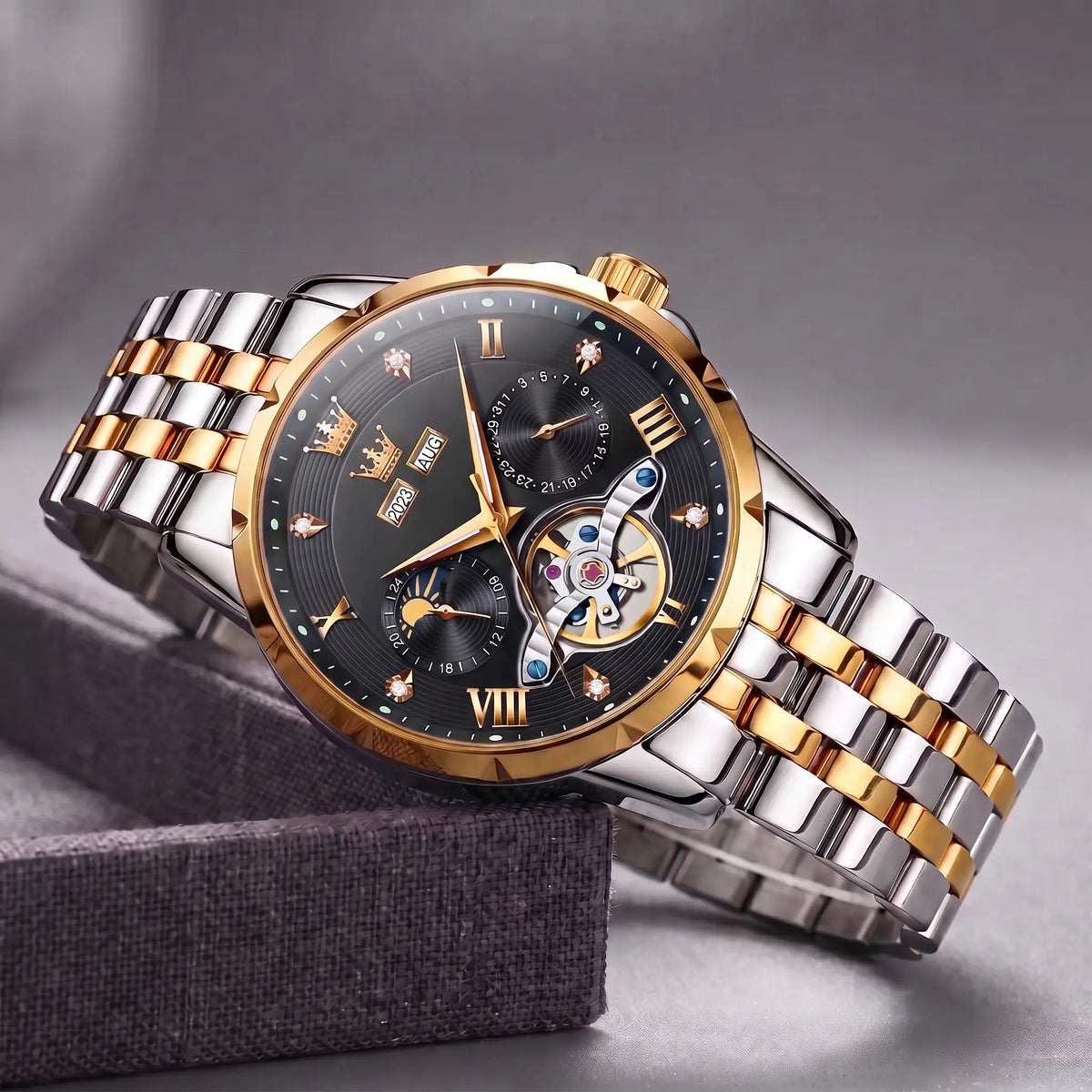 Open Heart Watch with gold bezel, black dial, moon phase and exposed gear window, on a two tone steel band