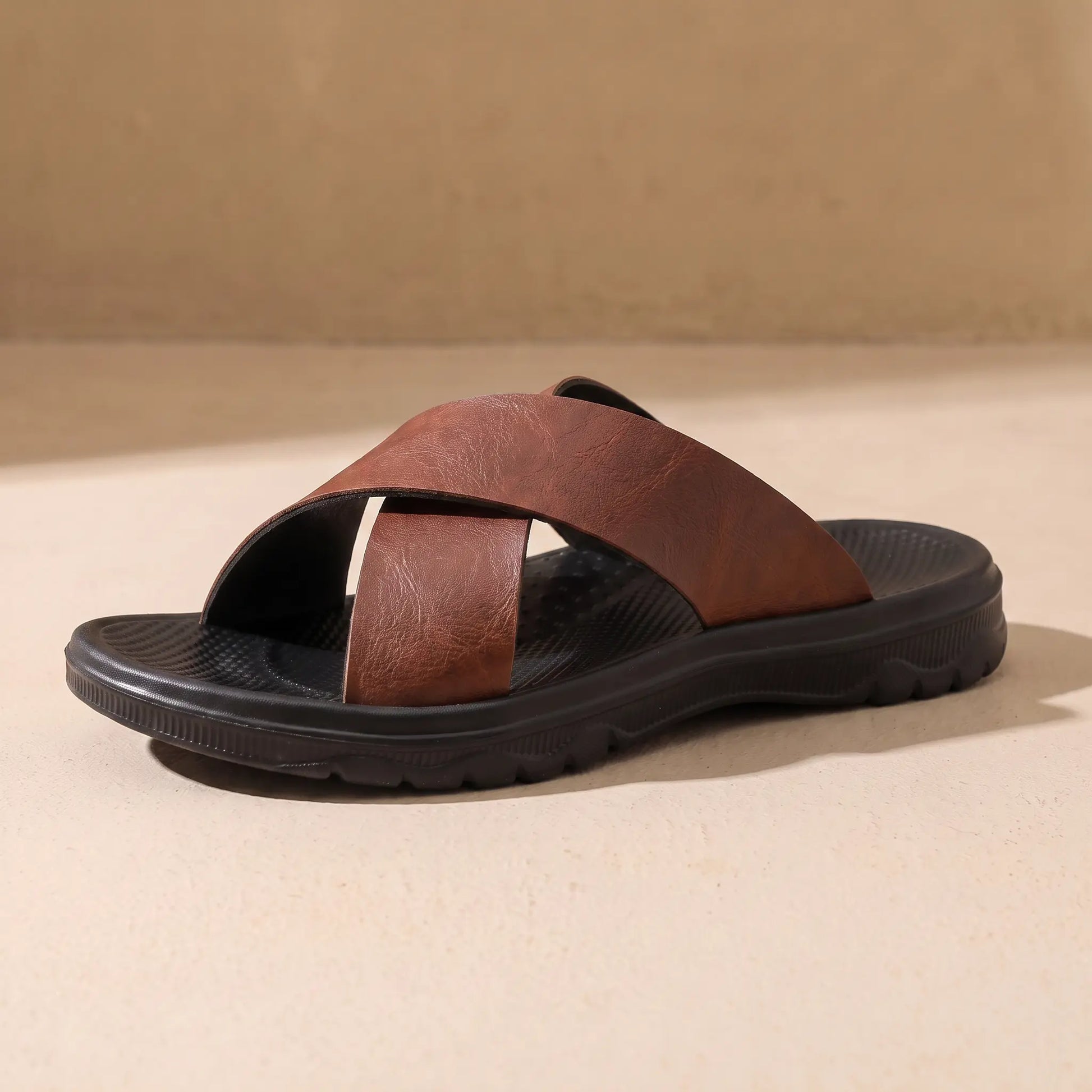 Red brown men's cross-strap slide sandal on sandy floor