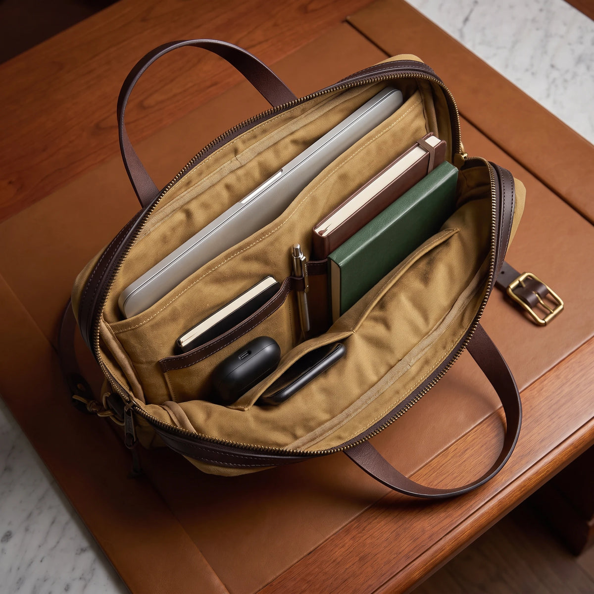 Padded laptop briefcase interior with laptop, books and gadgets