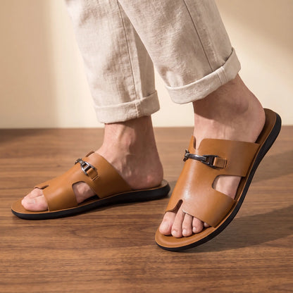 Man wearing the pair of brown buckle slides