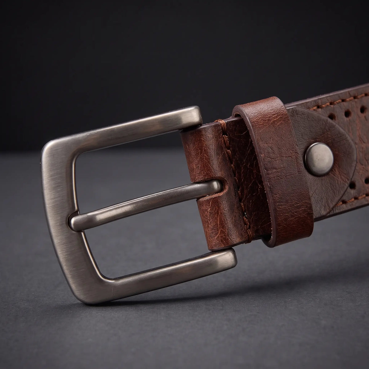 Close up of the gunmetal buckle, keeper loop and metal rivet stud on the Punched Hole Belt