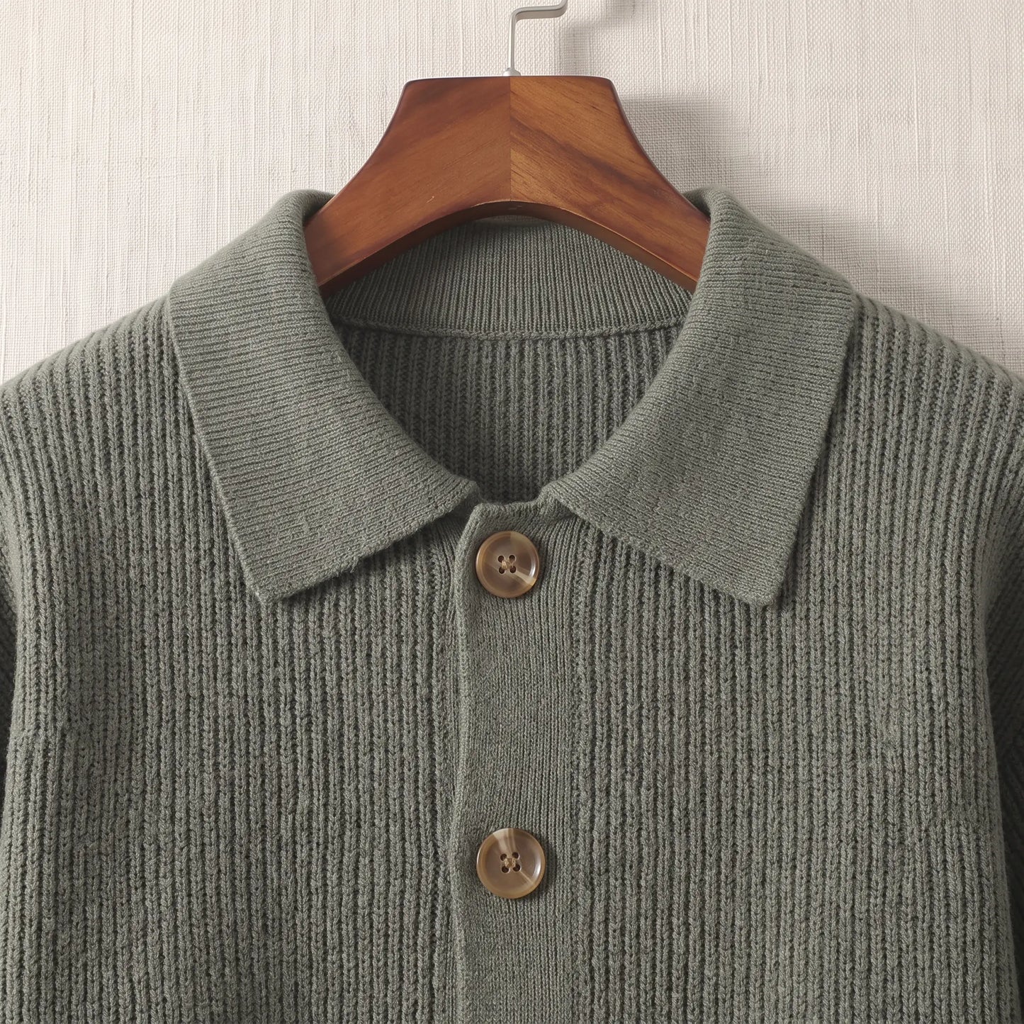 Close up of the flat turn down collar and round wood tone buttons on the green Rib Texture Jacket