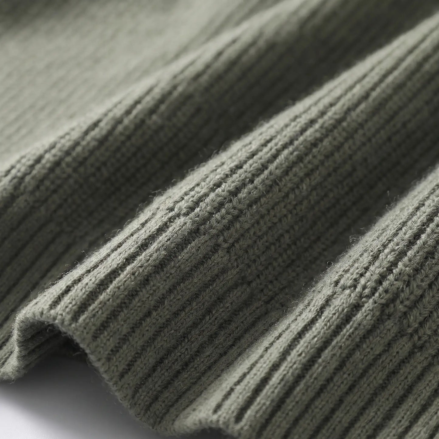 Close up of the vertical rib knit texture and cuff on the green Rib Texture Jacket