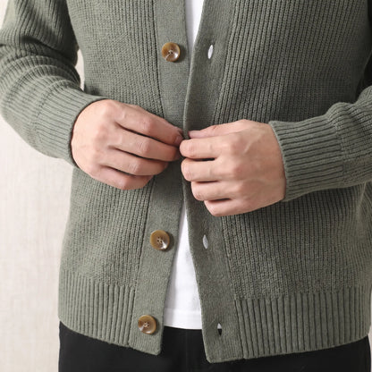 Man fastening a button on the green Rib Texture Jacket worn over a white tee