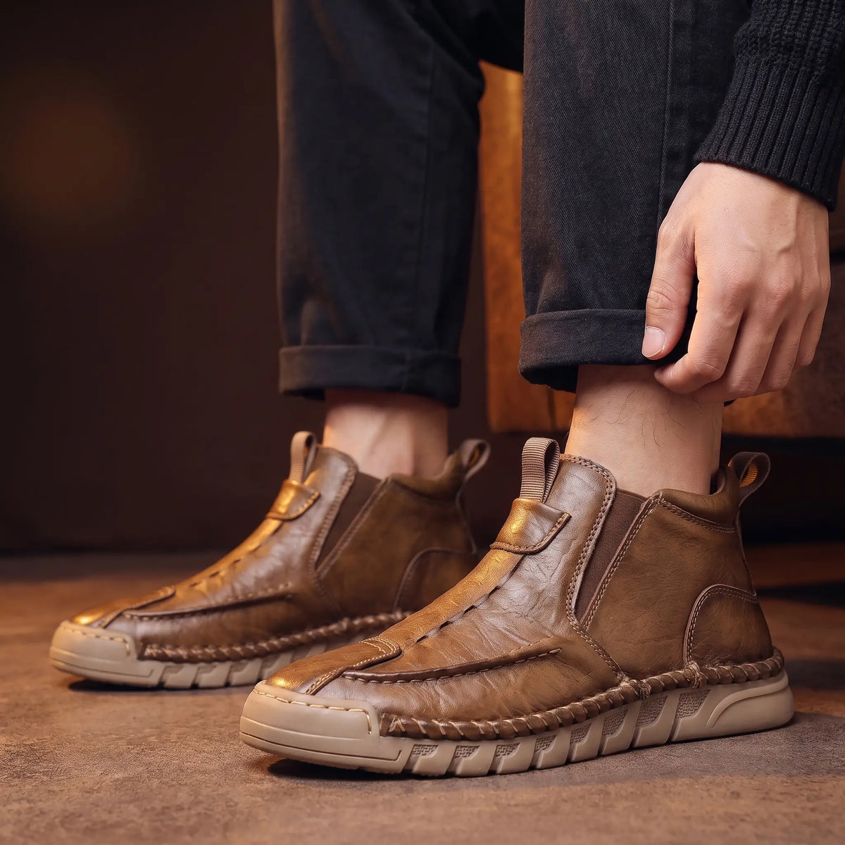 Man wearing the Saddle Seam Boots, settling one boot into place