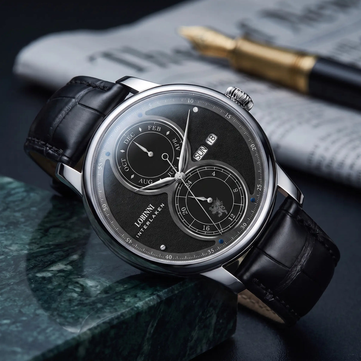 Silver case black split dial automatic watch on a black leather strap