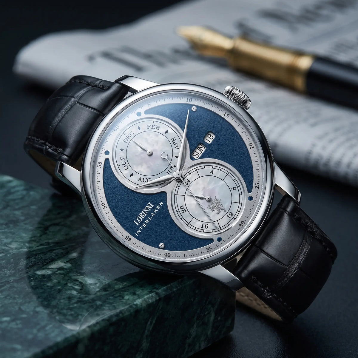 Silver case blue split dial automatic watch on a black leather strap
