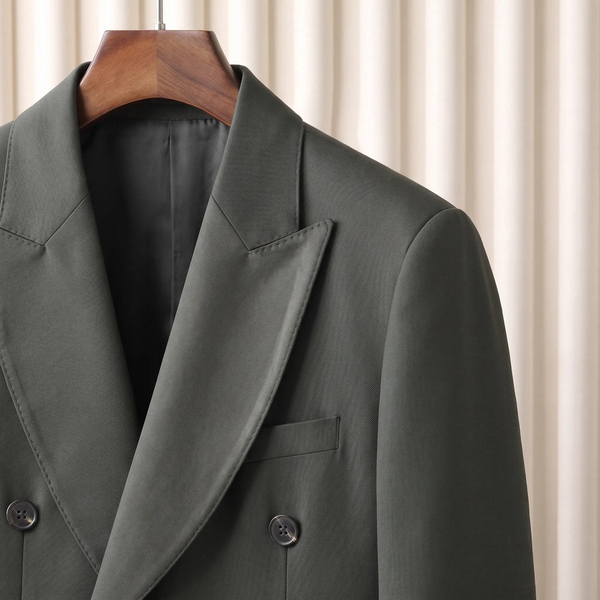 Close up of the satin faced lapel and double breasted buttons on the green Satin Lapel Blazer