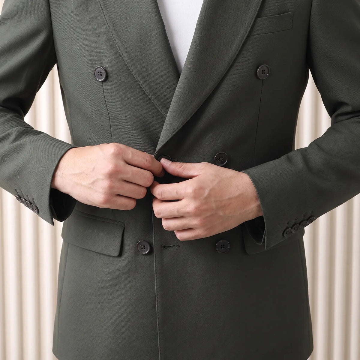 Man fastening the green Satin Lapel Blazer over a white tee