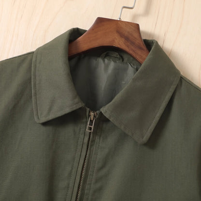 Close up of the pointed collar and metal front zip on the green Sleeve Pocket Bomber