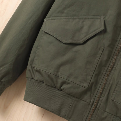 Close up of the flap hip pocket and ribbed waistband on the green Sleeve Pocket Bomber