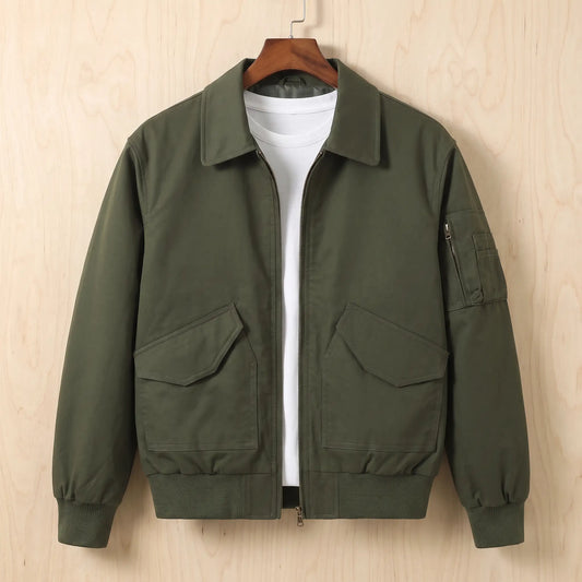 Sleeve Pocket Bomber in green, a short flight bomber jacket with a zip front, hip flap pockets and a zipped sleeve pocket on a wooden hanger