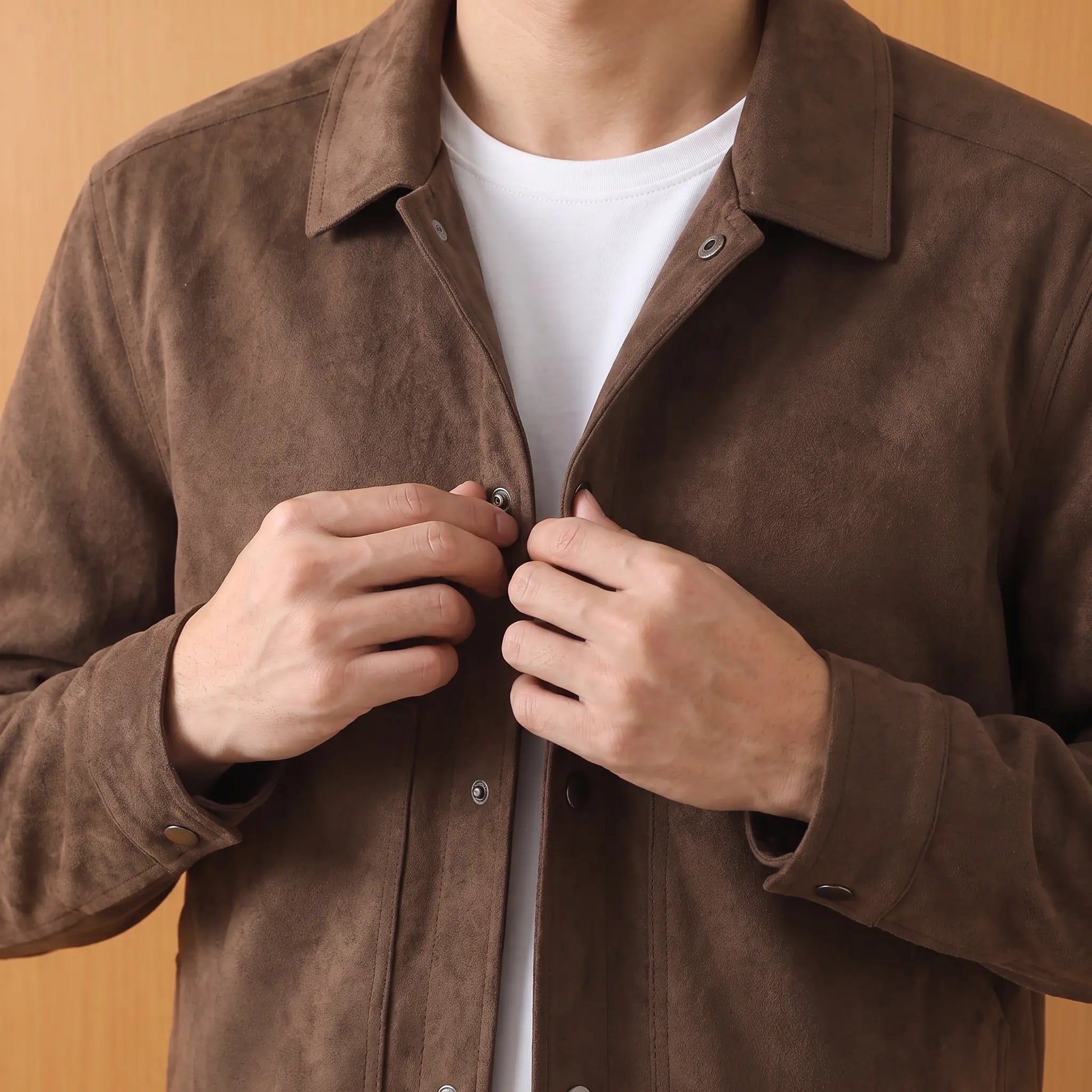 Man fastening the brown jacket