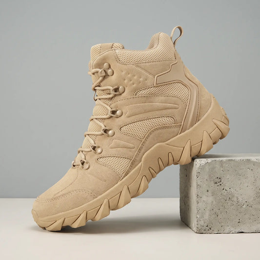 Soft Suede Hikers in beige, a mid cut suede and mesh boot with fabric lace loops and a toothed sole, on a concrete block