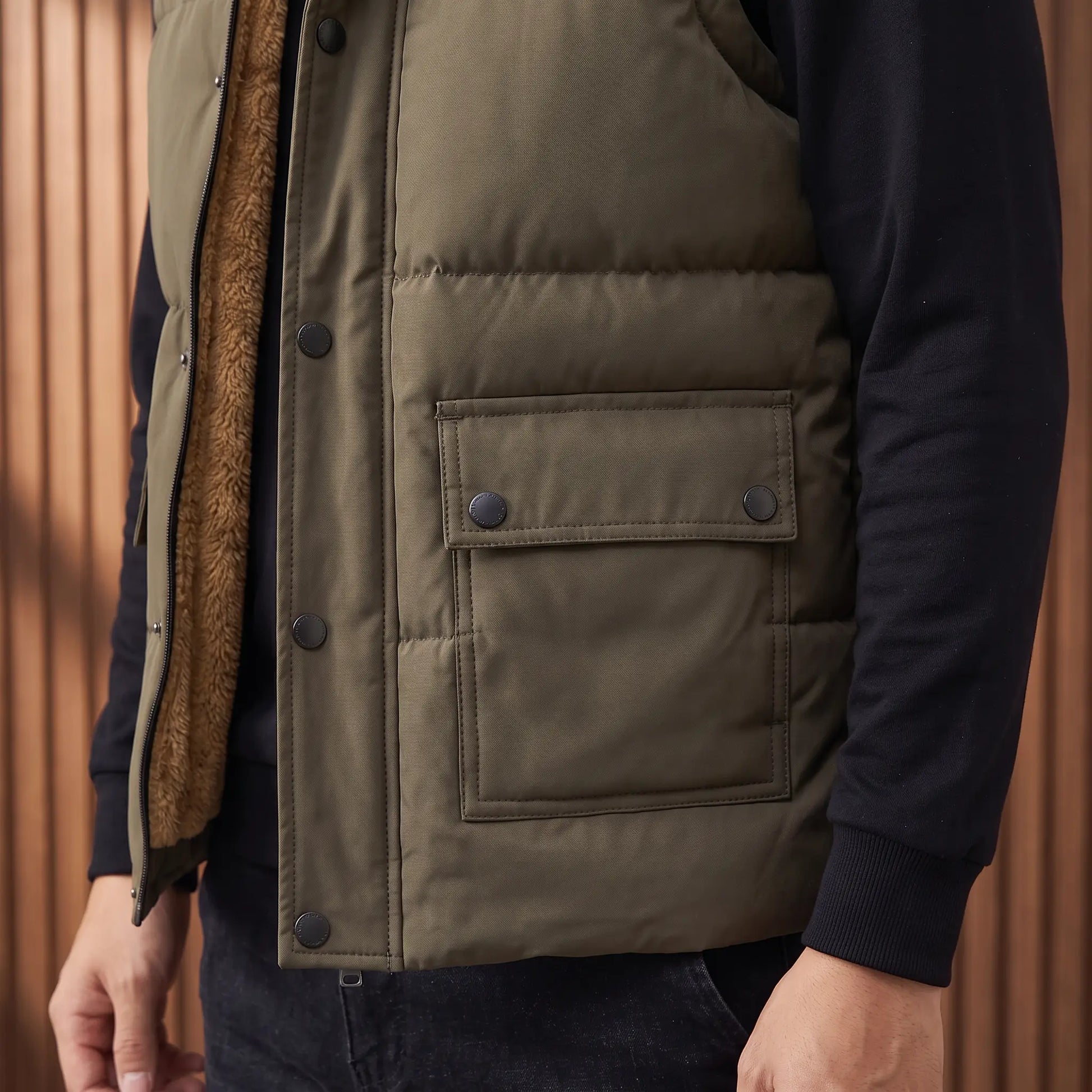 Close up of the flap pocket, hem and fleece lining on Stand Collar Vest