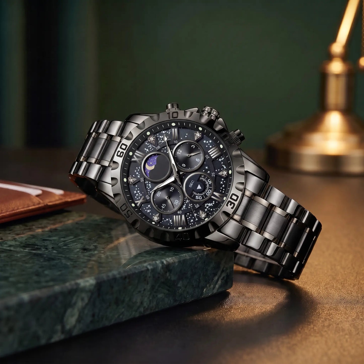 Starry Dial Watch in all black with black star pattern dial and black steel band, resting on a green marble ledge