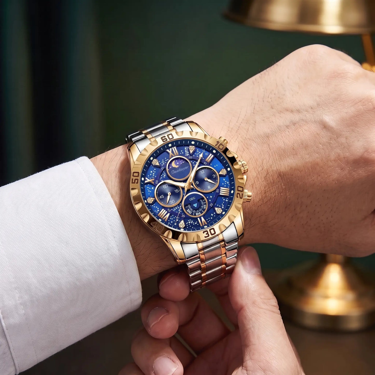 Man fastening the gold and blue Starry Dial Watch onto his wrist over a white shirt cuff