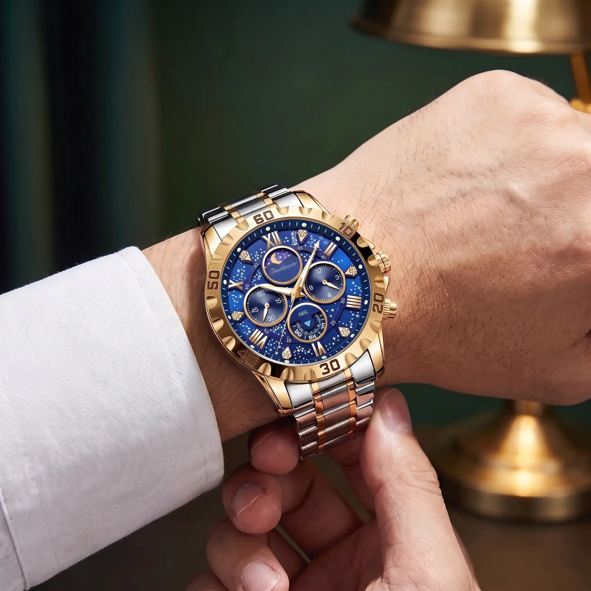 Man fastening the gold and blue Starry Dial Watch onto his wrist over a white shirt cuff