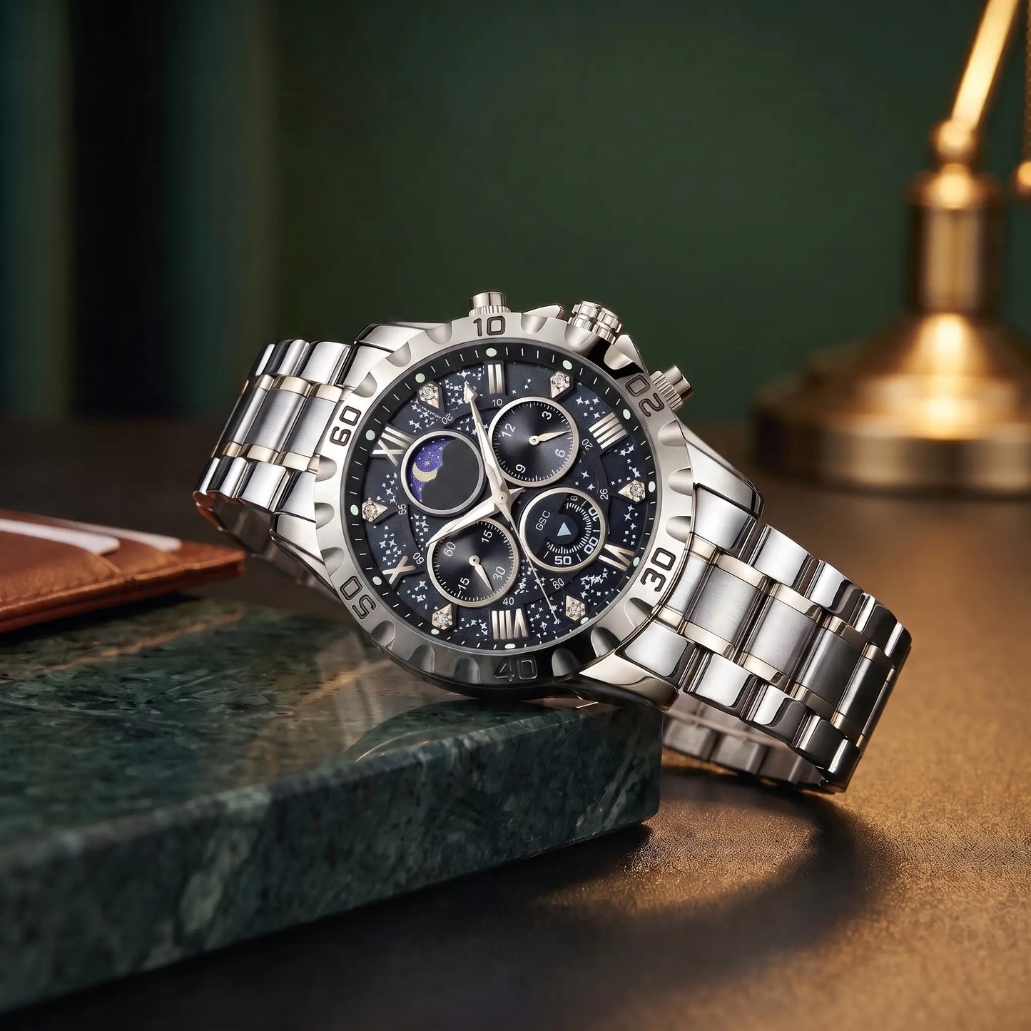 Starry Dial Watch with silver steel case, black star pattern dial and steel band, resting on a green marble ledge