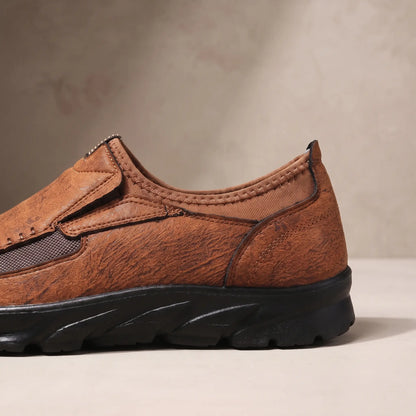 Close up of the padded collar, elastic side panel and sculpted bottom on the light brown Stitched Apron Loafers