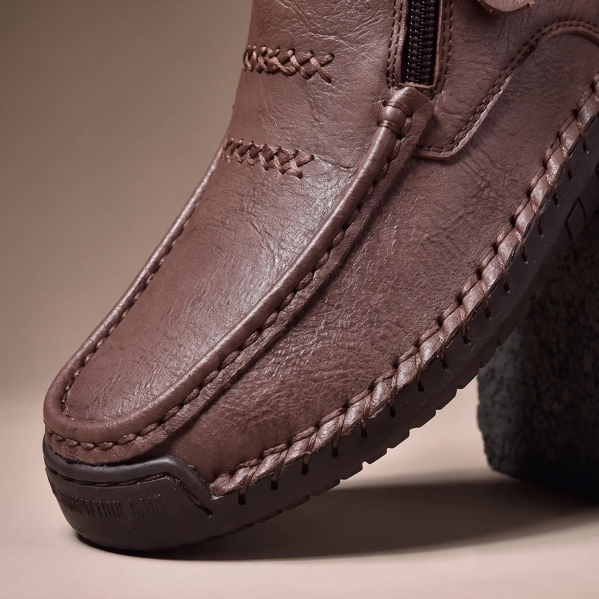 Close up of the hand stitching and rubber sole on Stud Strap Boots