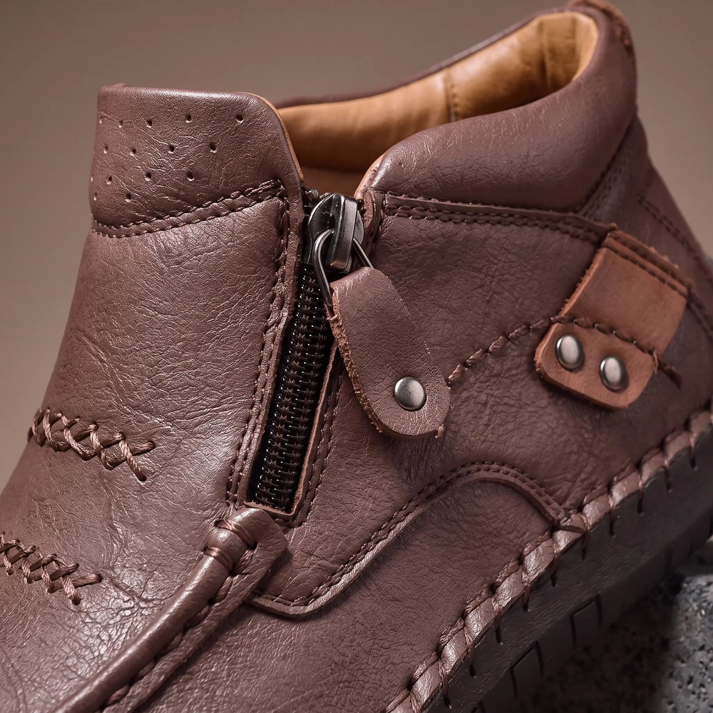 Close up of the side zip and studded leather strap on Stud Strap Boots