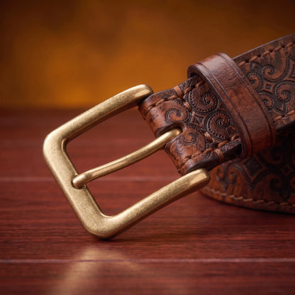 Close up of the antique brass prong buckle and leather keeper loop on the Tooled Pattern Belt