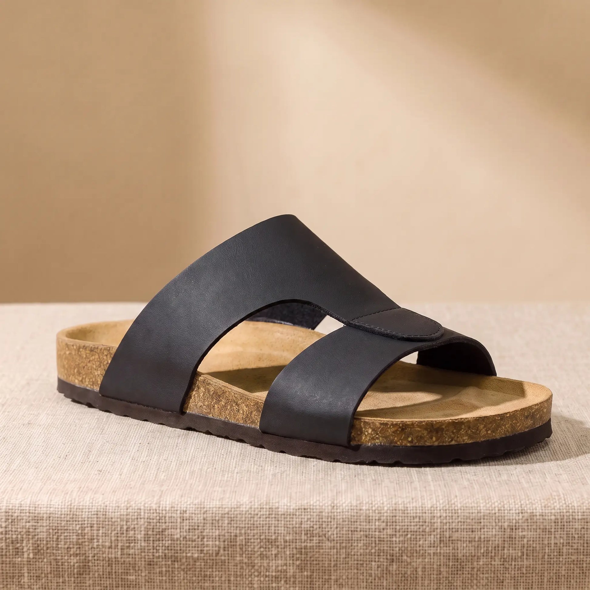 Two Strap Slides in black, a cork footbed slide with two wide bands across the front, on a linen platform