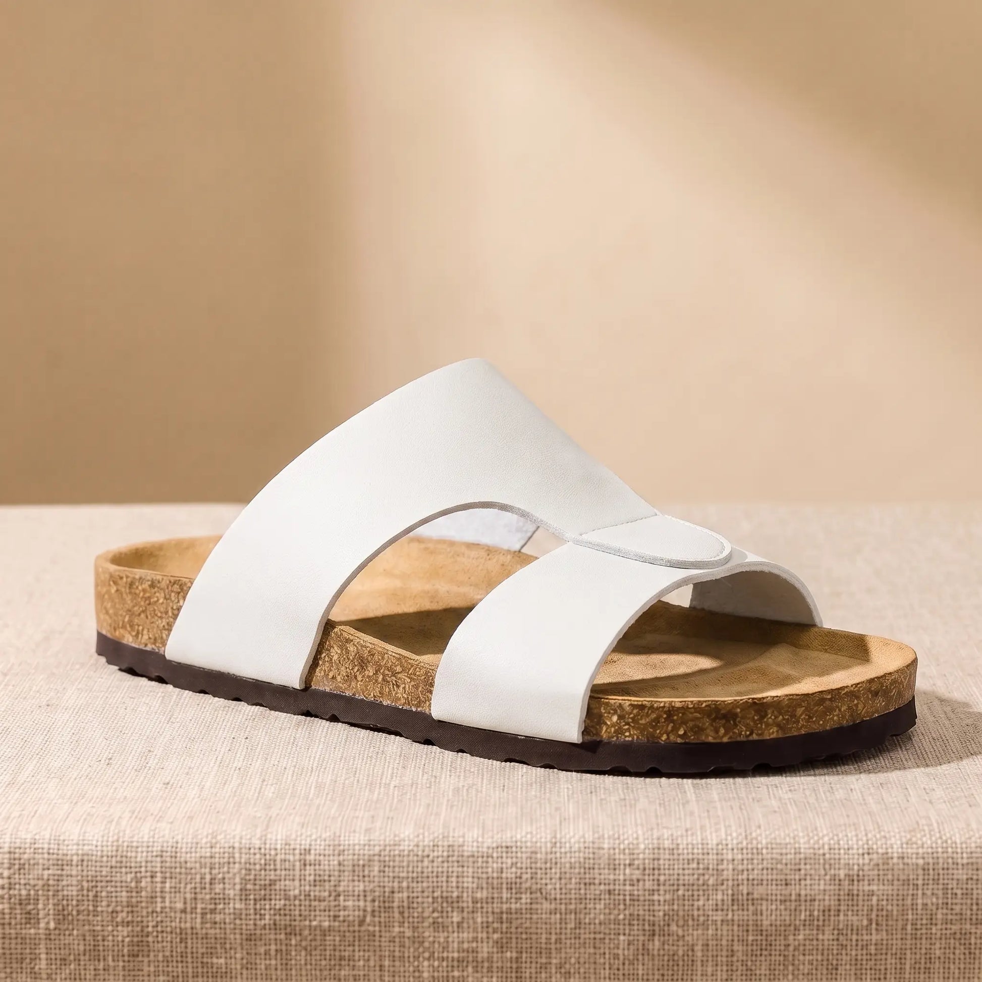 Two Strap Slides in white, a cork footbed slide with two wide bands across the front, on a linen platform