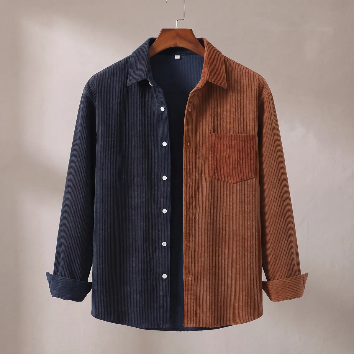 Two Tone Overshirt in blue and brown, a two tone colour blocked corduroy overshirt with a patch chest pocket on a wooden hanger