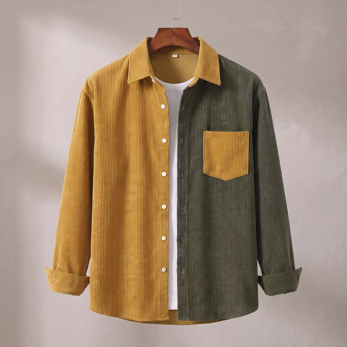 Two Tone Overshirt in yellow and green, a two tone colour blocked corduroy overshirt with a patch chest pocket on a wooden hanger