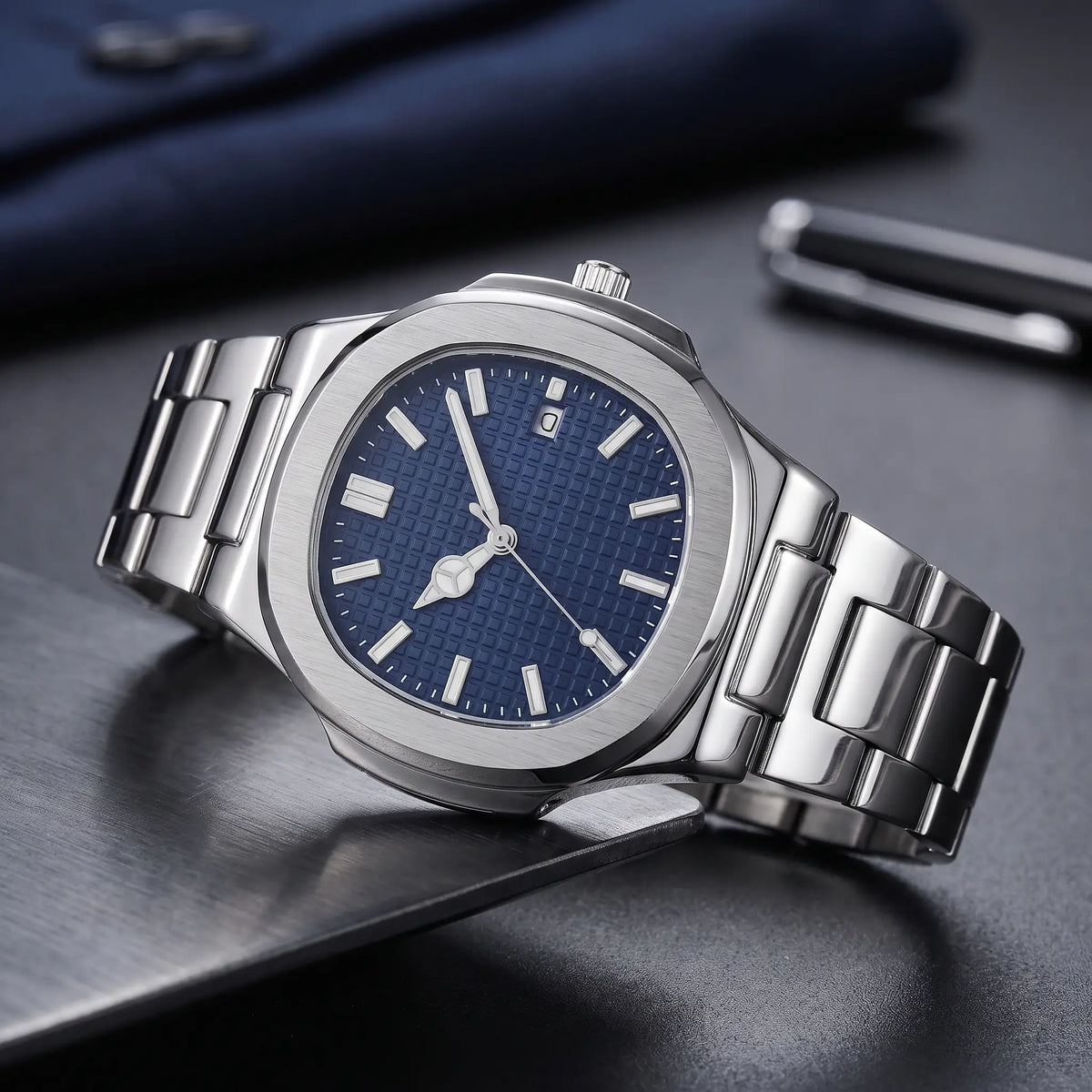 Octagonal steel watch with navy waffle dial on a brushed steel plate