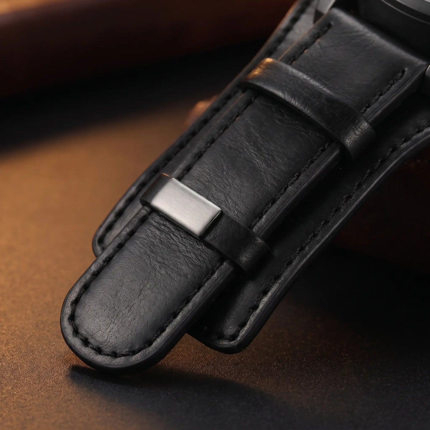 Close up of the wide stitched leather cuff and steel keeper loop on the Wide Cuff Watch